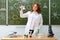 Redhead woman chemistry teacher at lesson at school. Analyzes, tests and research in the school laboratory