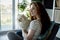 Redhead woman with a dog in the living room