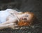 Redhead woman laid down on the gravel.