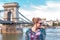 Redhead woman looking away at Chain Bridge, Budapest, Hungary