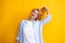 Redhead woman with movement hair. Studio shot of carefree redhead woman smiles cheerfully isolated over vivid yellow