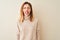 Redhead woman wearing elegant turtleneck sweater standing over  white background sticking tongue out happy with funny