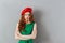 Redhead young angry lady in green dress