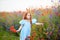 Redhead young girl gathers a bouquet of wild flowers