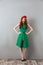Redhead young screaming lady in green dress and red beret
