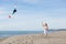 Redheaded model holding kite and posing