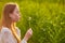 Redheaded teen girl blowing on dandelions