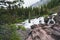 Redrock Falls along Swiftcurrent Pass hiking trail in Glacier National Park on an overcast day