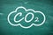 Reduce carbon emissions. Chemical formula CO2 on green chalkboard