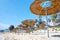 Reed beach umbrellas, sunshades against blue sky on the beach. Bamboo parasols, straw umbrellas on on white sandy