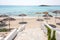 Reed beach umbrellas, sunshades against blue sky on the beach. Bamboo parasols, straw umbrellas on on white sandy tropical