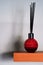 reed diffuser on shelf with shadows on wall