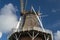 Reed hood or classical windmill against blue sky with clouds