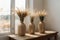 Reed plume stem, vase with dry flower on window, dried pampas grass. Decorative flower arrangement in home interior, trendy home d
