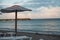 Reed umbrella and sunset over the beach