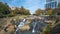 Reedy River Waterfalls in downtown of Greenville city in South Carolina. Falls Park Riverwalk at Liberty bridge