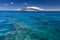 Reef in clear water with view of West Maui Mountains from south shore. Maui, Hawaii, USA