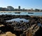 Reef at low tide, fishing boats and city