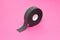 Reel of double-sided tape on a pink background, close-up, double-sided adhesive tape, element