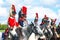 Reenactors dressed as Napoleonic war soldiers ride horses