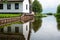 Reeuwijk, South Holland, The Netherlands - Reflections of a residential house and garden in the canal