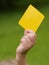 Referee hand with yellow card