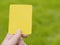 Referee hand with yellow card