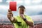 Referee showing the red card in the soccer stadium