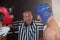 Referee stopping aggressive male boxers