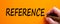 Reference symbol. Hand writing the word `reference`, isolated on beautiful orange background. Business and reference concept, co