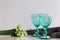 Refhesing drink in blue vintage goblets on the white background with srping flowers