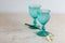 Refhesing drink in blue vintage goblets on the white background with srping flowers