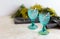 Refhesing drink in blue vintage goblets on the white background with srping flowers