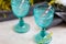 Refhesing drink in blue vintage goblets on the white background with srping flowers