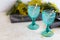 Refhesing drink in blue vintage goblets on the white background with srping flowers