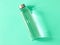 Refillable drinking water bottle on mint green background