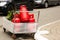 Refillable red gas cylinders are in a trailer outside.