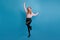 Refined blonde girl dancing and waving hands. Studio shot of magnificent french woman posing on blue background