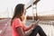 Refined caucasian girl in sport uniform sitting at stadium after training. Enthusiastic woman with