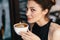 Refined Woman Enjoying Cappuccino or Latte on a vibrant, colorful background indoors