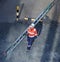 REfinery worker overhead image carrying a ladder wearing full PPE