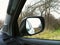 Reflected in a rearview. In the background forest. Autumn. Winter. Car. Nature