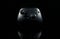 Reflecting Xbox one video game controller on shiny black surface