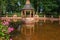 Reflection of the arbor in the water of the pond