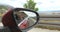 Reflection of attractive blonde woman in side mirror of convertible