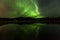 Reflection of Aurora Borealis over Olnes pond in Fairbanks, Alaska