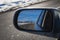 reflection of beautiful winter landscape with a road and mountains in snow in rearview mirror of the car. The concept of