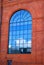 Reflection of of blue sky in window of old factory in Lodz