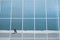 Reflection of a breakwater with fisherman in panoramic glass windows