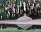 Reflection of Buddha sculpture and guarding dog under colourful laterns in the water